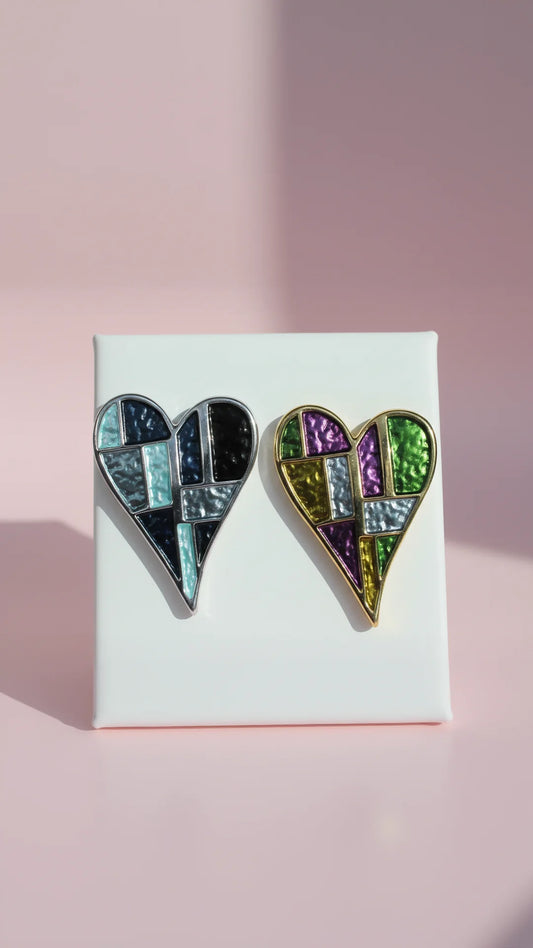 Heart-shaped brooches on a white card with a pink background