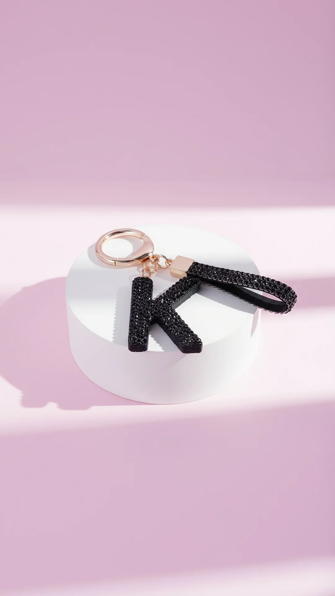 Keychain with 'K' letter on a pink background