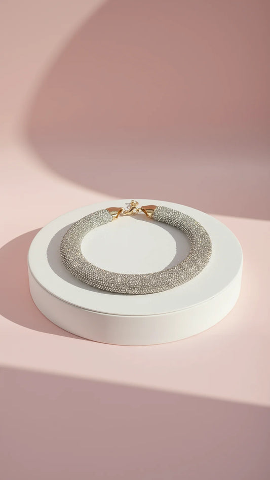 Necklace on a white stand with a pink background