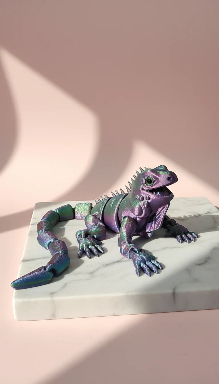 Colorful lizard figurine on a marble base with a pink background