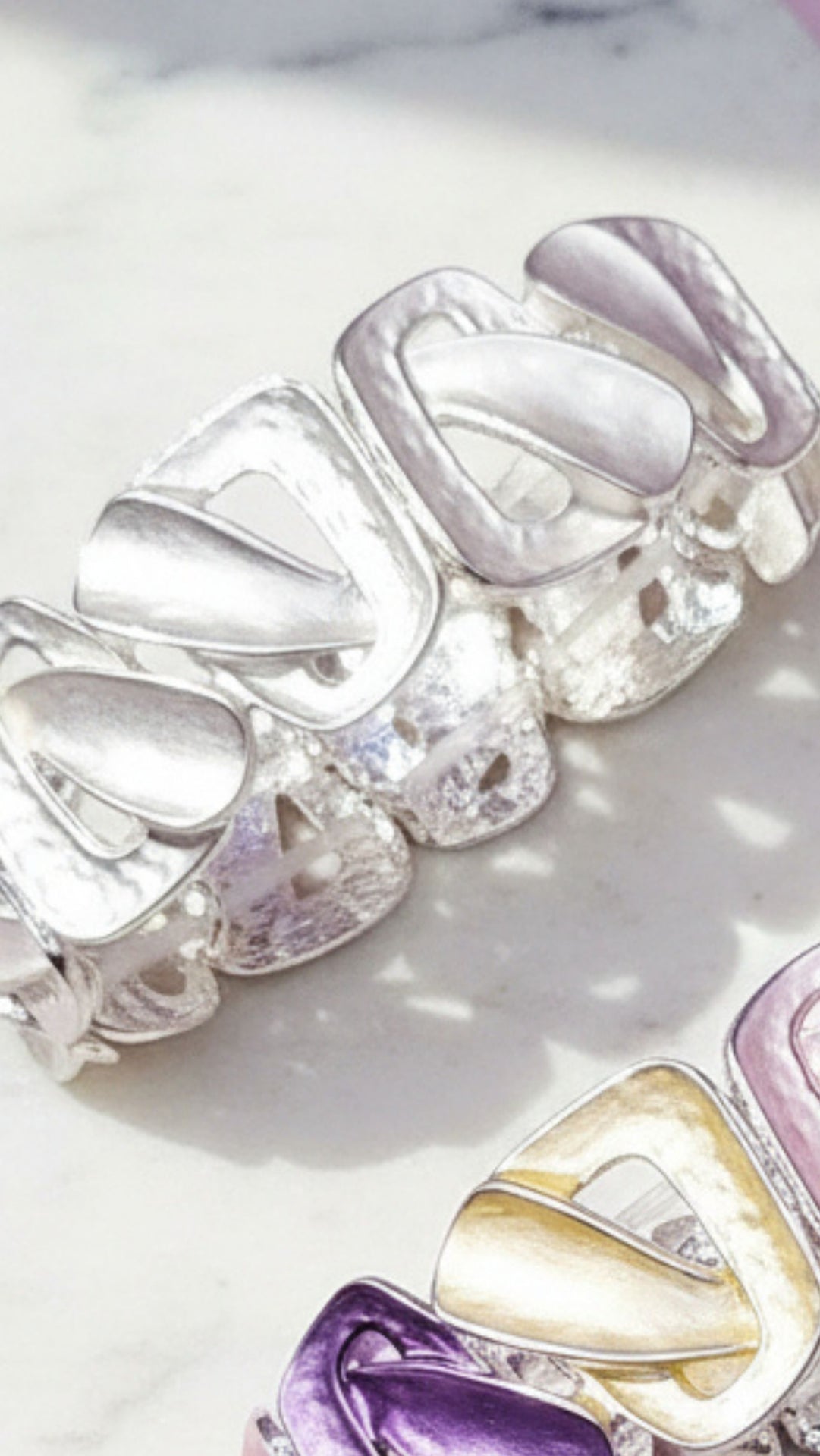 Set of silver and gold bracelet on a white background