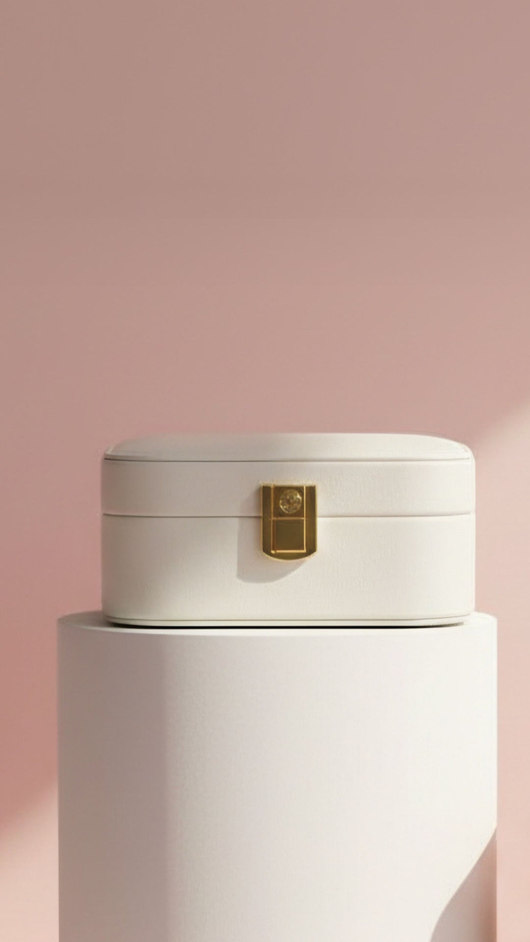 White square shape jewellery box displayed on a white surface with a pink background