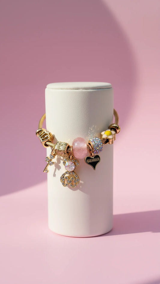Golden bracelet with chars on a white display against a pink background