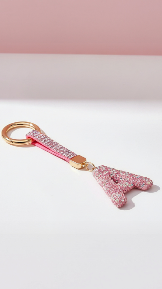 Pink letter 'A' keychain with gold accent on a white background