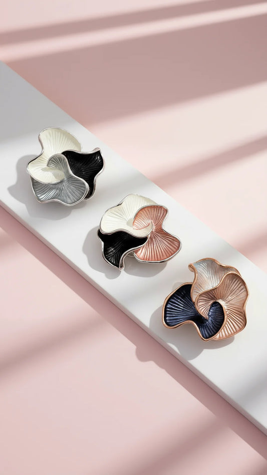 Three colorful brooches displayed on a white surface with pink background