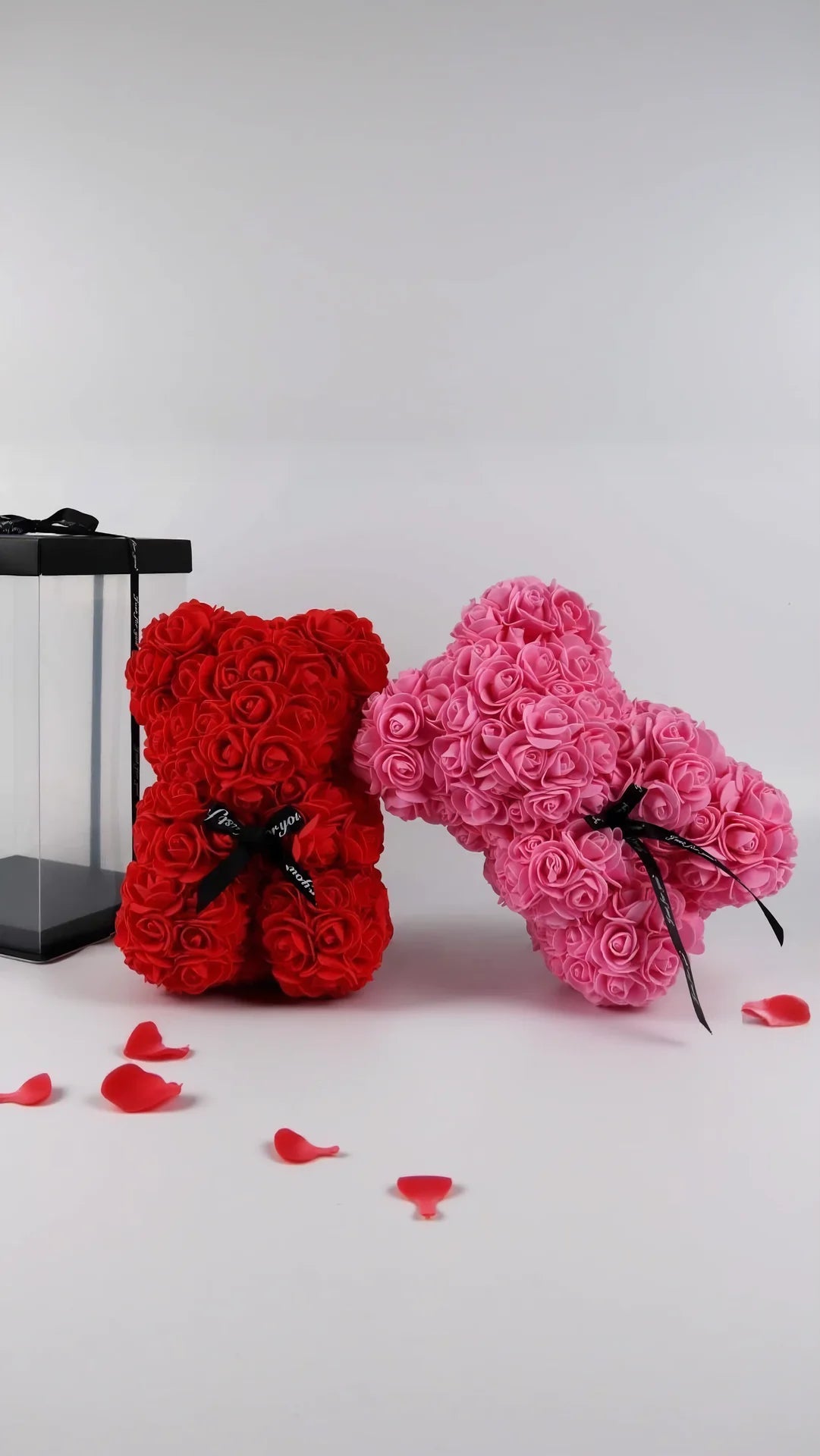 Red and pink rose bears with black ribbons on a white background